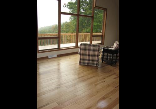 light wooden flooring and large window 