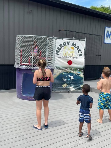 Kids lining up in front of a dunk tank