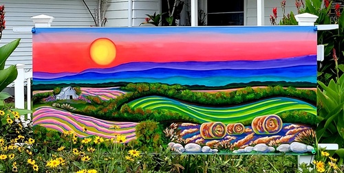 sunset landscape painting on sign outside of building