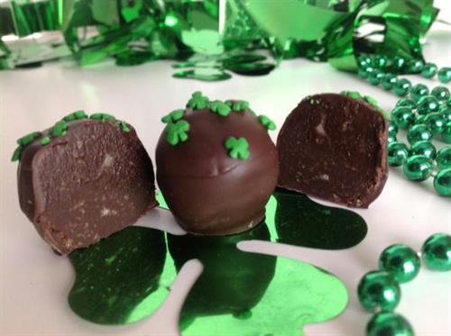 chocolate surrounded by green St. Patrick Day accessories