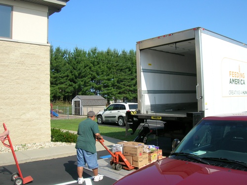 man unloading boxes from truck at Sauk Prairie area food pantry