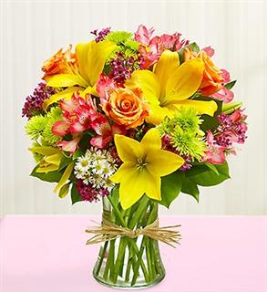 Bouquet of yellow, green, pink and peach flowers in a vase