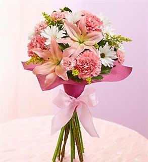 standing bouquet of pink flowers with a pink ribbon