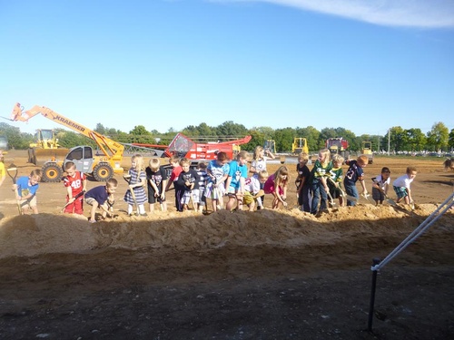 kids digging in dirt with shovels