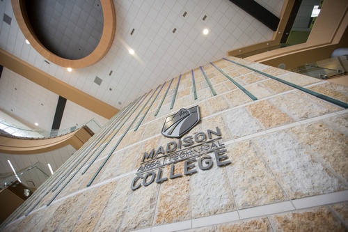 Madison College logo on wall inside building