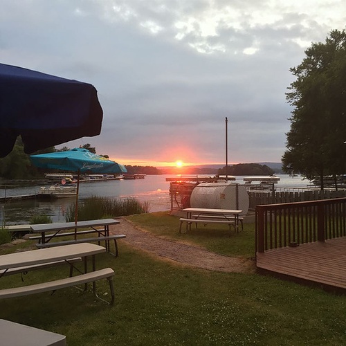 view of a sunset on lake wisconsin at sunset harbor bar and grill
