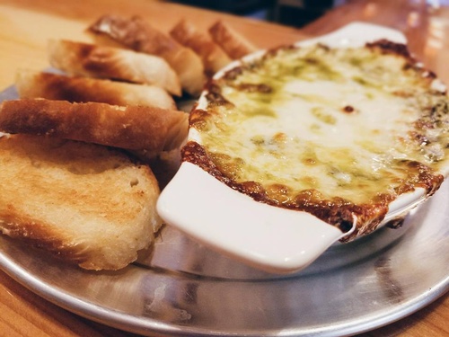 Close up of cheese dip with bread pieces