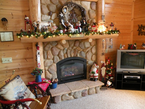 Inside of log cabin showing the fireplace in the living room