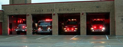 4 Firetrucks parked in garage openings at the fire department