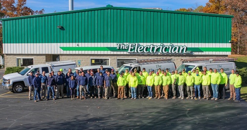 Employee group photo outside of The Electrician building