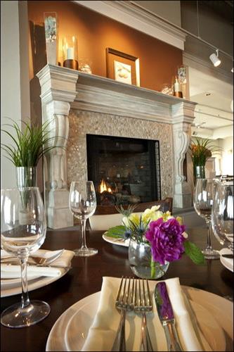 An elegant stone fireplace is a focal point in the relaxed "beach chic" dining room.