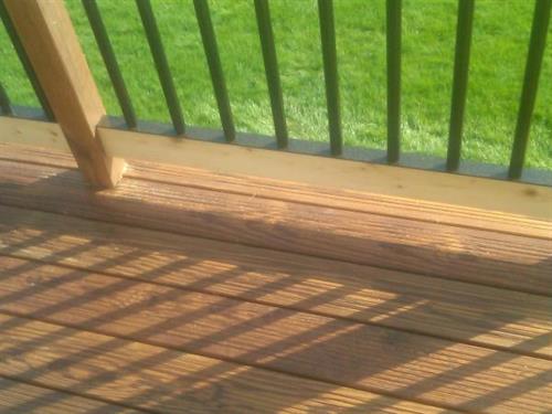 This is thermally treated wood. It is brown all the way through and doesn't need any staining for several years. Notice the railing system eliminates the need to stain between spindles.