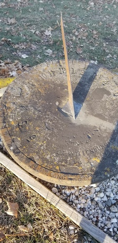 A sundial handmade by Elmore Wittenburg (1895-1975) from a grindstone on his nearby farm, now marks time in the church cemetery