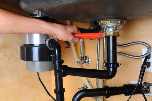 Gallery Image plumber-fixing-pipe-under-sink.jpeg