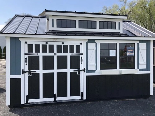 Gallery Image Blue_shed_with_white_shutters._black_trim._and_three_upper_windows.jpg