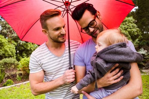 Gallery Image smiling-gay-couple-with-child-in-garden-PGA22PQ-scaled.jpg