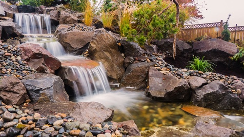 A Greenhaven Landscapes-designed water feature - a Vancouver WA backyard waterfall with large stones
