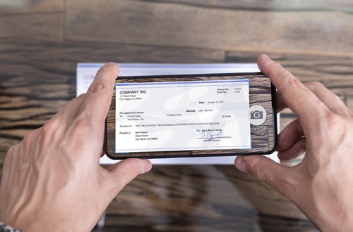 Gallery Image Man-Taking-Photo-Of-Cheque-To-Make-Remote-Deposit-1186375221_1263x834-min.jpg