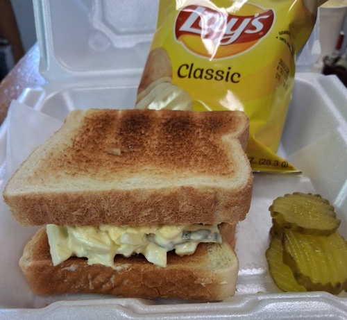 Egg Salad Sandwich with Chips and pickle 