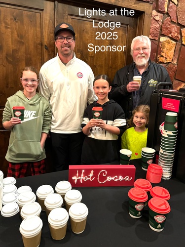 Owner Chris Ray & family serving complimentary hot cocoa and coffee at the 2025 Lights at the Lodge (photo by Erica Volkir)