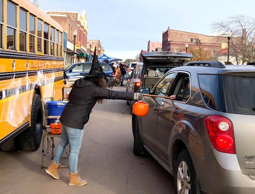 Gen from Ludolph Bus hands out candy at the Chamber's annual Downtown Candy Walk & Truck or Treat