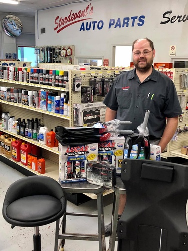 Store manager Ryan Mollema with prizes for the 2021 Chamber Car Cruise-In (photo: Erica Volkir)
