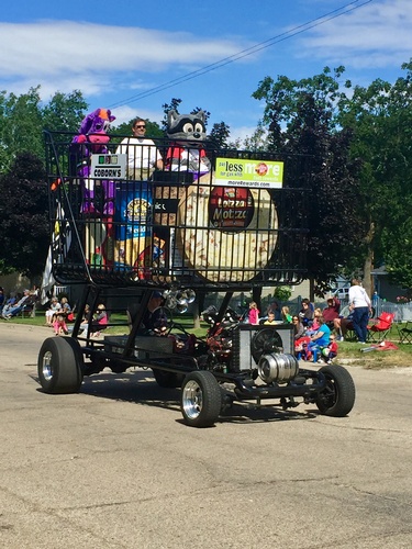 Store Manager Keith Nettik & Friends delighted kids along the Water Tower Festival Parade Route in what could be the World's Largest Shopping Cart (photo by Erica Volkir)