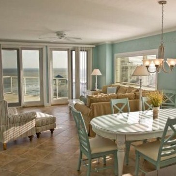 Sunny living room in The Meridian with panoramic views of the Ocean.