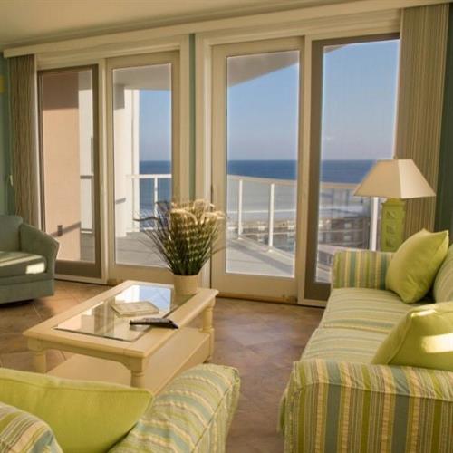 Sunny living room in The Meridian with panoramic views of the Ocean.