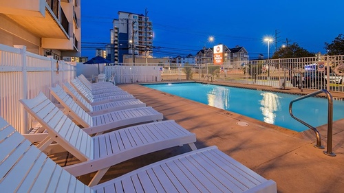 Gallery Image outside-pool-at-night-with-lounger-chairs.jpg