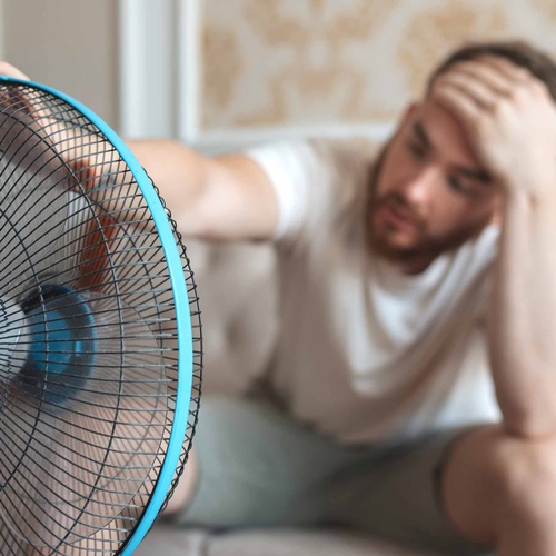 Gallery Image man-using-electric-fan-cooling-off-during-hot-weather.jpg