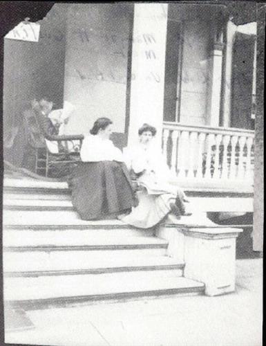 Members of the Minor Family sit on the porch