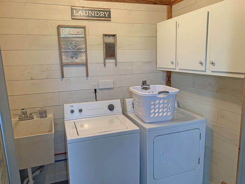 Washer & dryer included. Utility sink and overhead storage cabinets.