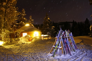 The Magic Meadows Yurt aglow while skiers enjoy dinner inside.
