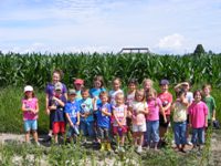 Junior Farmer's camp kids in front of corn maze