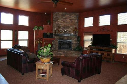 Numerous high set windows with faux painting and custom rock fireplace