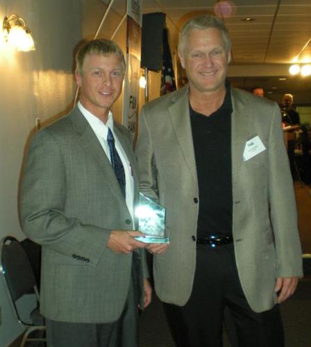 Derek and Kent Burnstad receiving Member of the Year Award