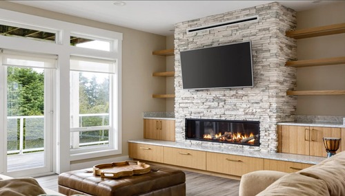 Custom living room with floor-to-ceiling stone fireplace and built-in cabinetry by Dihedral Builders in Anacortes, WA.