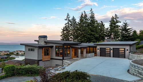 Modern waterfront custom home with panoramic views and contemporary architecture built by Dihedral Builders in Anacortes, WA.